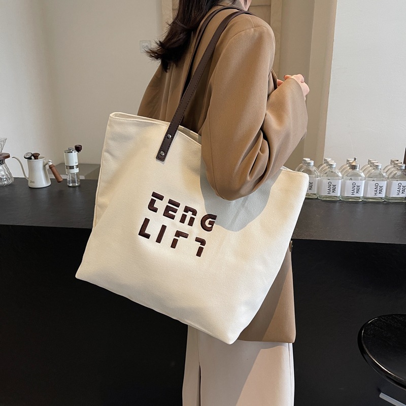 Simple letter large-capacity commuting canvas bag for women 2025 new spring casual and versatile student tote bag full figure