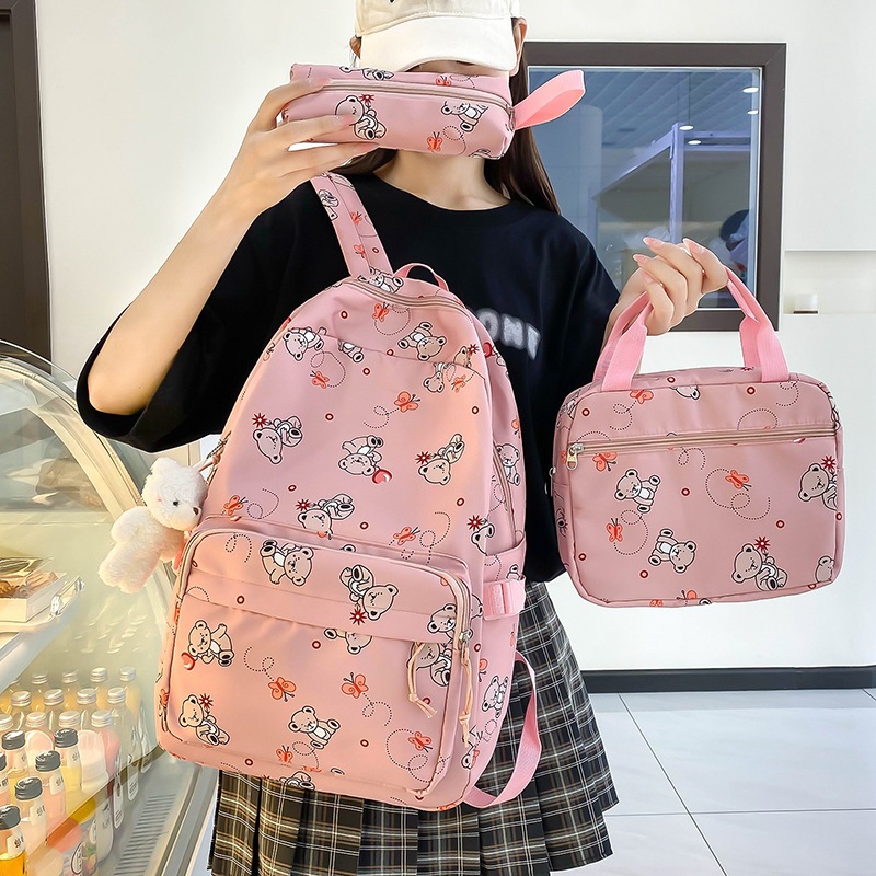 Student cartoon backpack for girls, Korean version, versatile, primary school campus backpack, lightweight nylon three-piece schoolbag full figure