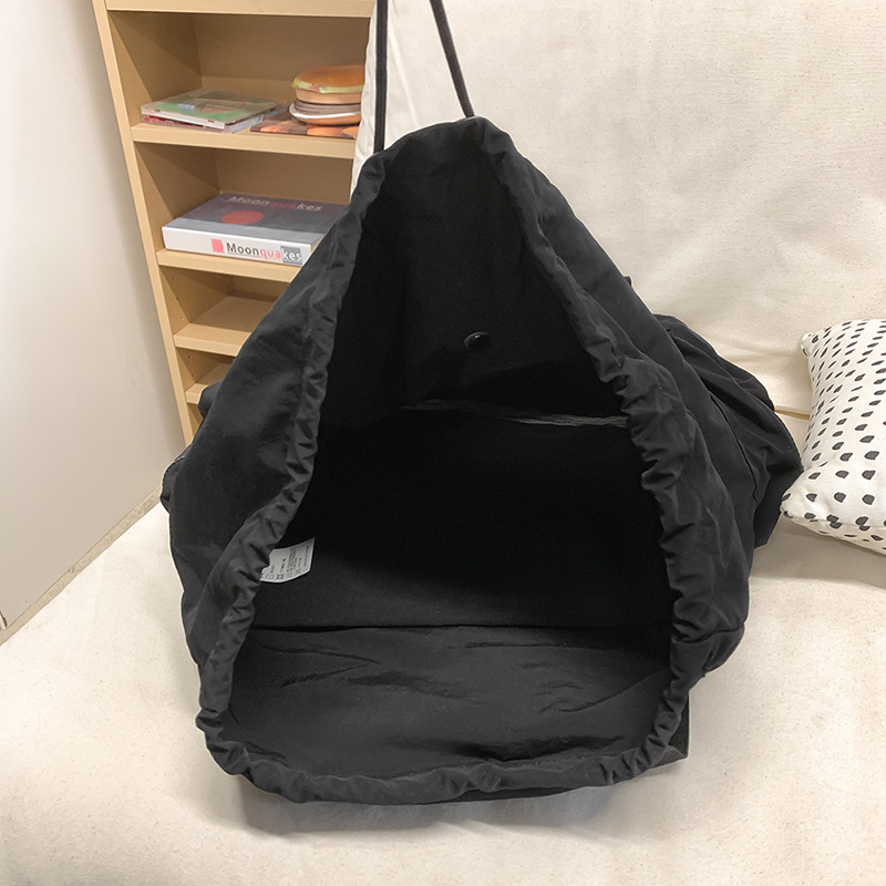 Ultra-light water-washable nylon commuting single backpack with drawstring, simple and versatile for daily use, portable and casual student schoolbag Application Scenario
