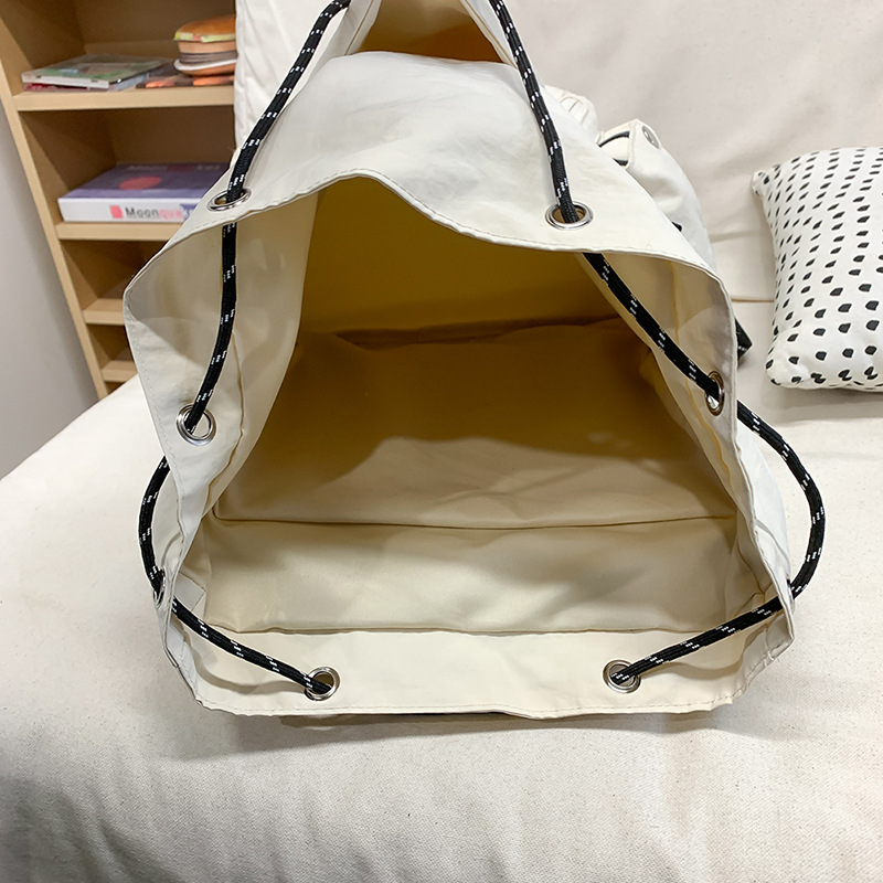 American-style ins flip-top schoolbag, simple and versatile backpack, lightweight solid-color backpack, travel and leisure drawstring single-shoulder bag Application Scenario