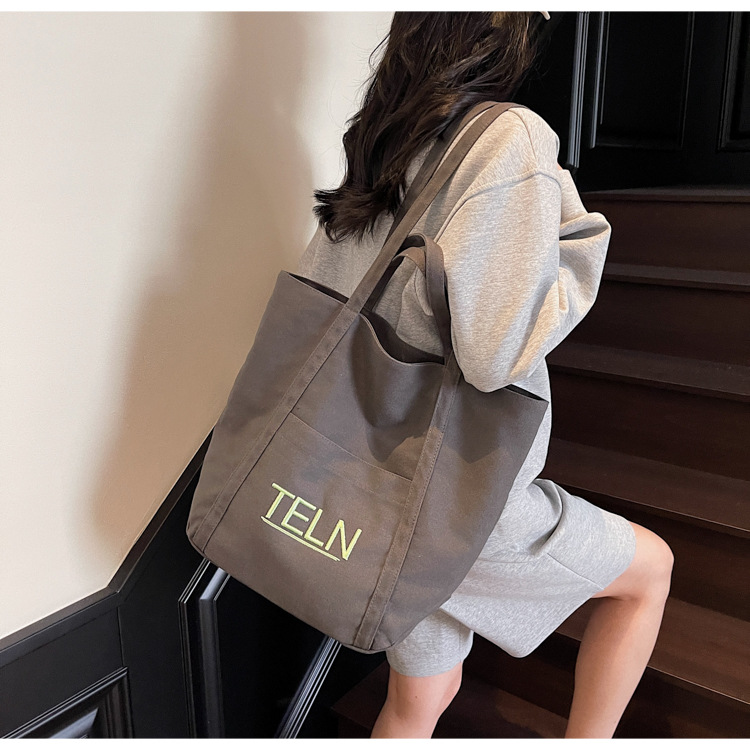 The 2025 new embroidered canvas bag is a versatile summer large-capacity handbag and a simple tote bag for classes and commuting details Picture