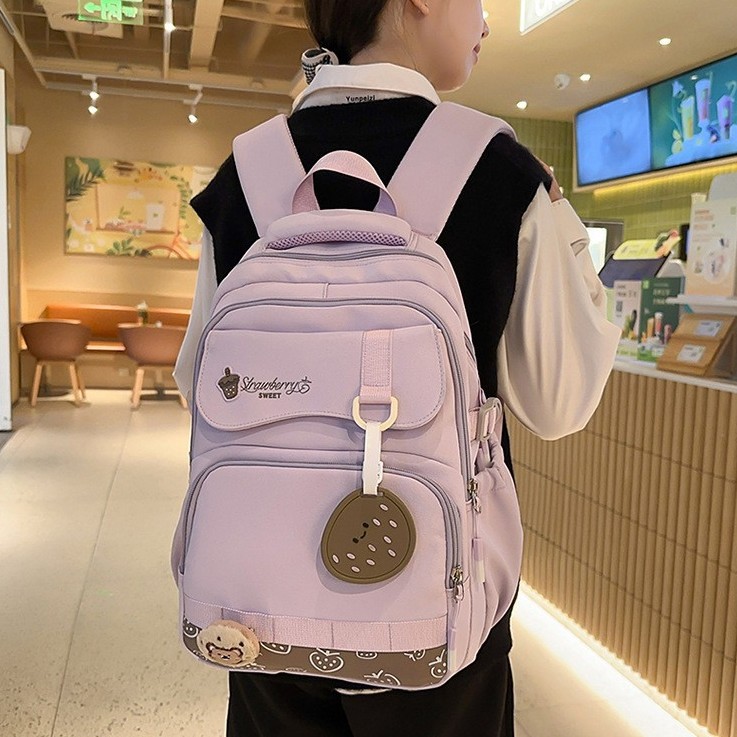 The new summer milk tea college style schoolbag has a high appearance level and contrasting colors. It is a multi-layered backpack for primary and secondary school students in grades three and six full figure