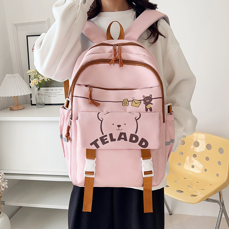 A lightweight and large-capacity backpack for women, a new Japanese style backpack with a high level of appearance and a college style, featuring multiple layers and cute cartoon bear designs details Picture