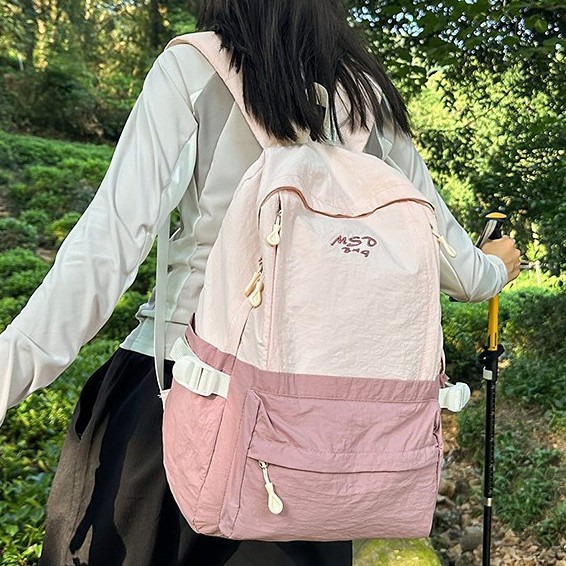 A new high-appearance-level forest-themed ins fresh and simple color-blocking backpack with a large capacity for women's lightweight travel full figure