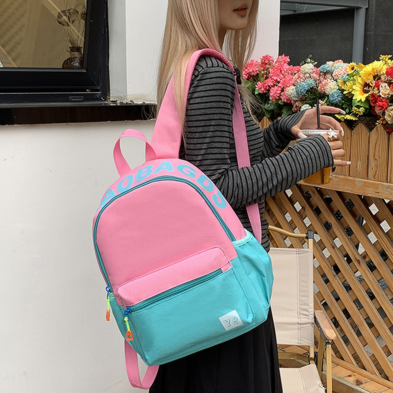 A new Japanese style backpack with a high level of appearance, sweet, fresh and cute printed words. It is a large-capacity casual backpack for junior and senior high school students full figure