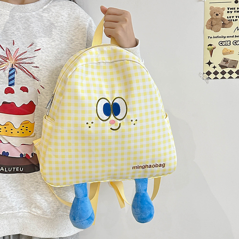 A cute and fresh checkered schoolbag for girls, a cute and ugly cartoon backpack for a small group of students, a lightweight backpack for girls details Picture