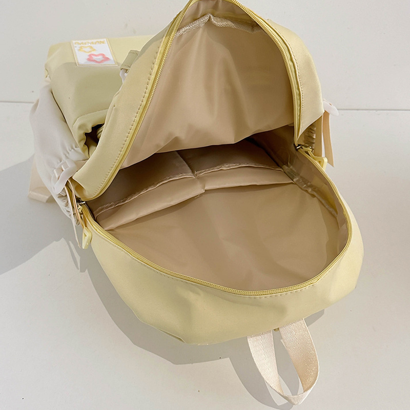 Cream-style campus junior and senior high school schoolbags, versatile large-capacity color-blocking casual backrest bags, travel and outings backpacks Application Scenario