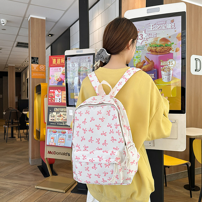 Large-capacity, high-appearance-level backpack with a bow for junior high school, 2025 new style ins fresh college backpack and schoolbag full figure