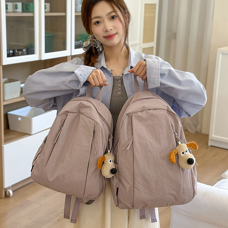 A lightweight, solid-color, simple and water-resistant casual travel backpack with a laid-back style from Korean Instagram full figure