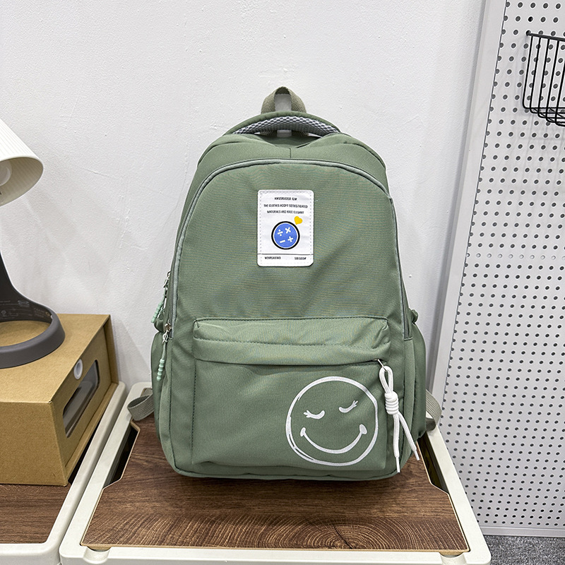 The 2024 new style of fashionable and simple backpacks for trendy boys and girls, large-capacity schoolbags for students, and cute smiling face printed backpacks details Picture