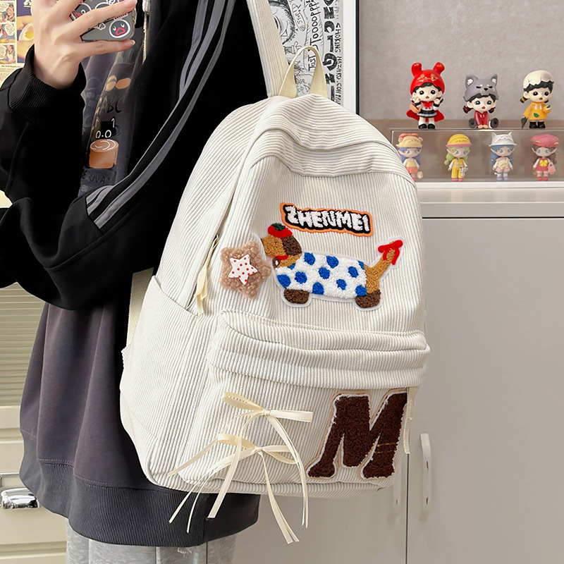 Cartoon dog corduroy girls' schoolbag 2024 New style cute bow backpack, high school and college students' backpack full figure