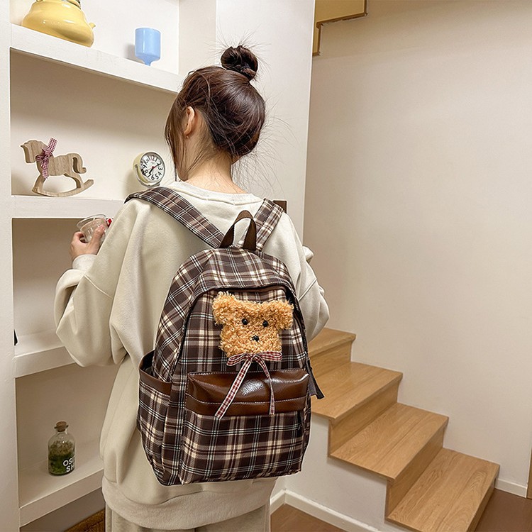 The new checkered backpack is retro and versatile. It's a cute, casual and lightweight backpack for college students going out and commuting full figure