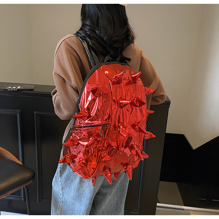 This trendy, spiky design backpack for foreign trade is cool and unique, with a shiny and three-dimensional surface. It's a student backpack that will make you go viral details Picture