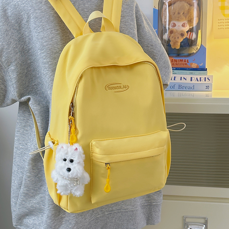 The 2025 new solid-color Ins-style backpack in Korean style is versatile and has a high level of appearance. It is a simple and large-capacity student schoolbag full figure