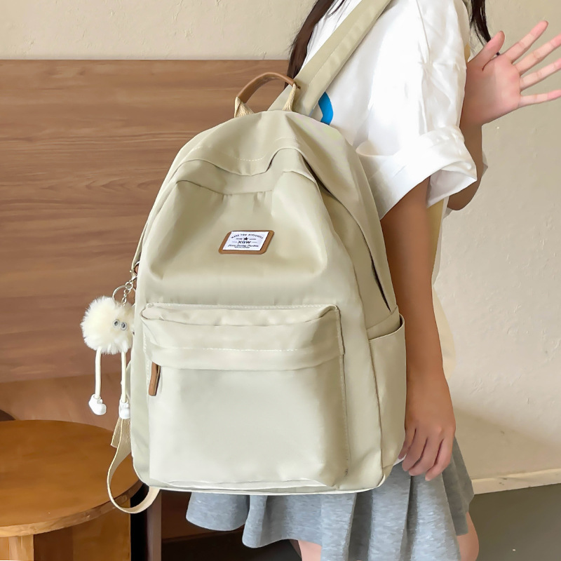The new Korean-style backpack for women is a versatile solid-color schoolbag with a simple and niche ins style. It is a lightweight and casual backpack for college students details Picture