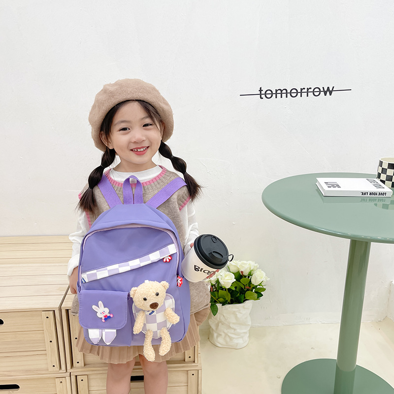 The new boys' and girls' schoolbags are cute and versatile. They are cartoon children's checkered bear dolls and backpacks details Picture