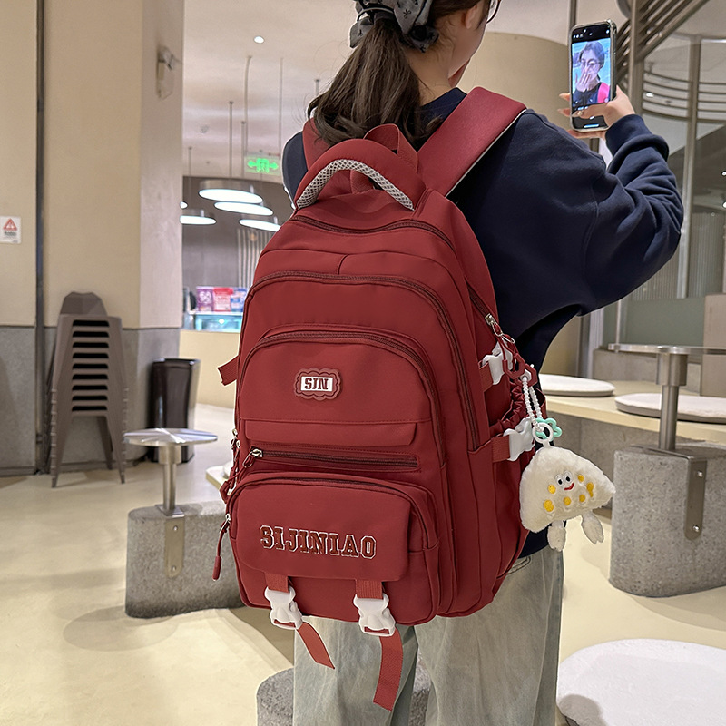 A new solid-color large-capacity backpack with a Japanese ins school style, versatile for junior high school students and featuring multiple compartments to reduce the load details Picture