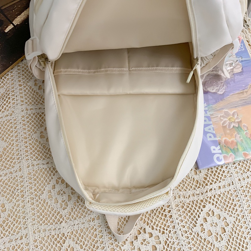A large-capacity backpack for girls, a new 2024 model with multiple compartments, cream color, forest style, and a fresh and light campus student bag Application Scenario
