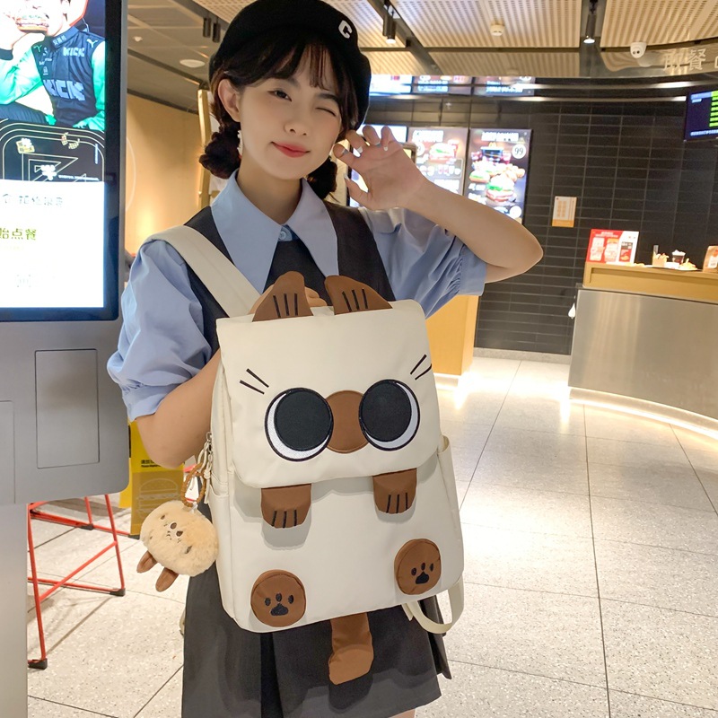The new Korean version schoolbag is lightweight and has a large capacity. It is a backpack for students in grades three to six and an ugly and cute cat backpack details Picture