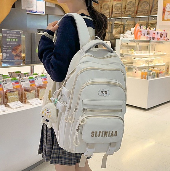 A new solid-color large-capacity backpack with a Japanese ins school style, versatile for junior high school students and featuring multiple compartments to reduce the load full figure