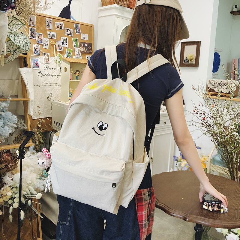 2025 New large-capacity student schoolbag, fashionable smiley face, simple and casual backpack, outdoor travel burden reduction backpack details Picture