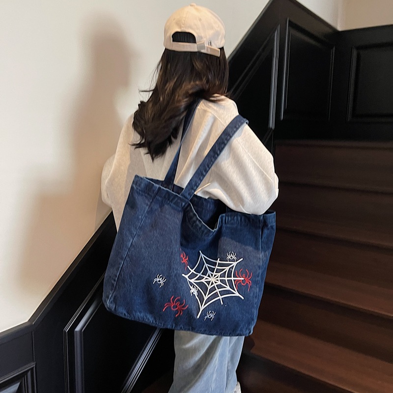 A niche and stylish embroidered denim backpack, a large-capacity versatile tote bag for commuting, and a retro casual student handbag details Picture