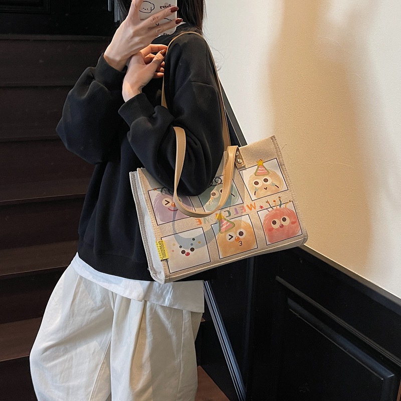 A large-capacity cartoon canvas bag for women, a new style of fashionable shopping bag for going out in 2025, a single-shoulder tote bag for moms details Picture