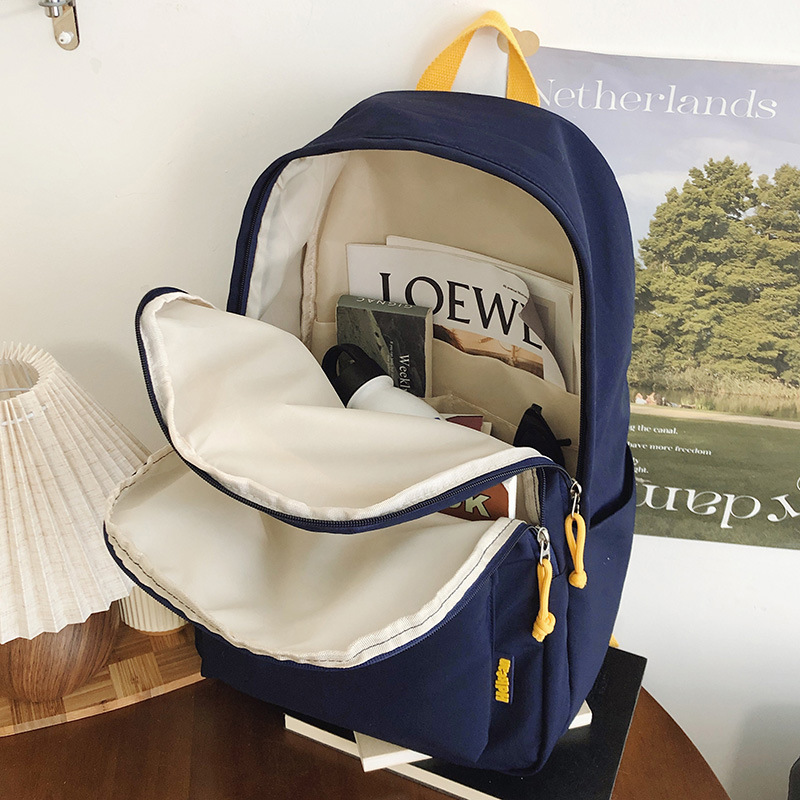 A new Korean-style ins high-appearment-level solid color simple letter backpack for couples, a casual, lightweight and large-capacity backpack Application Scenario
