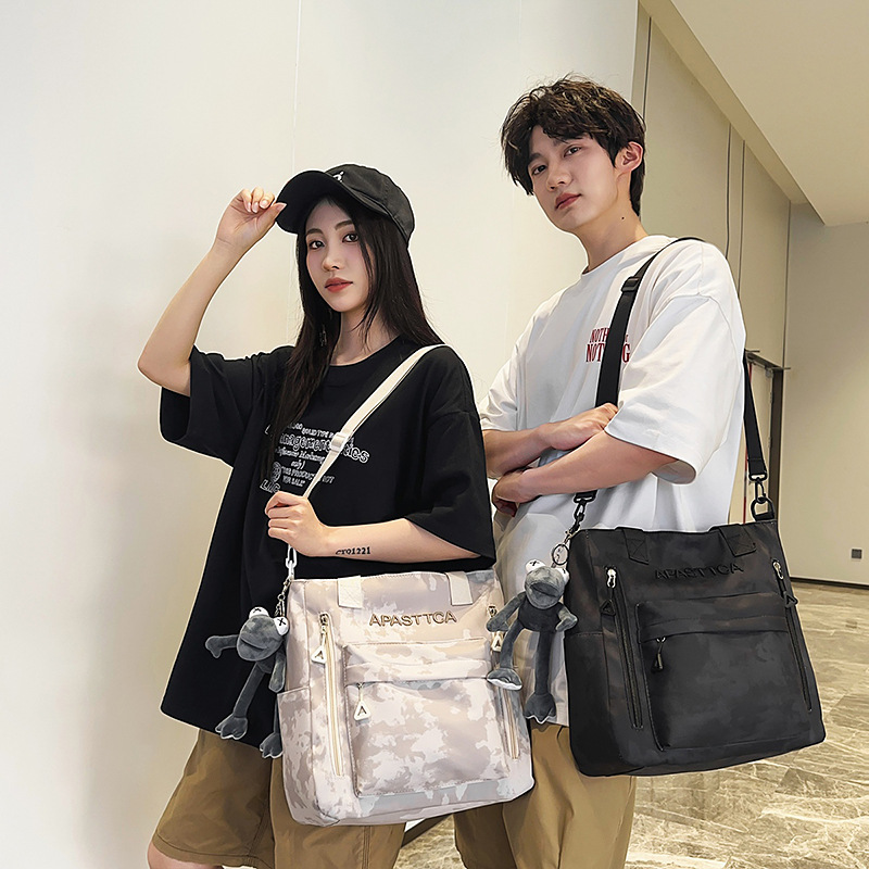 New fashionable schoolbag, dirt-resistant, dark color, niche and laid-back style, single-shoulder bag, graffiti, lightweight, commuting couple schoolbag details Picture