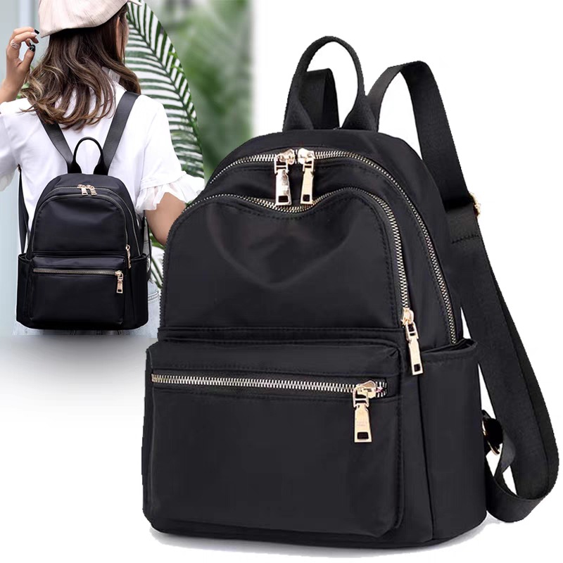 The 2025 new trendy travel Oxford fabric small backpack for women is a versatile and fashionable bag that goes well with women in summer full figure