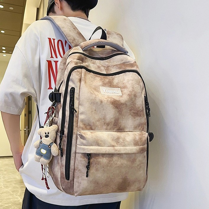 The new forest-style in high-appeal tie-dye color-blocking backpack is a casual, lightweight and large-capacity backpack for junior and senior high school students full figure