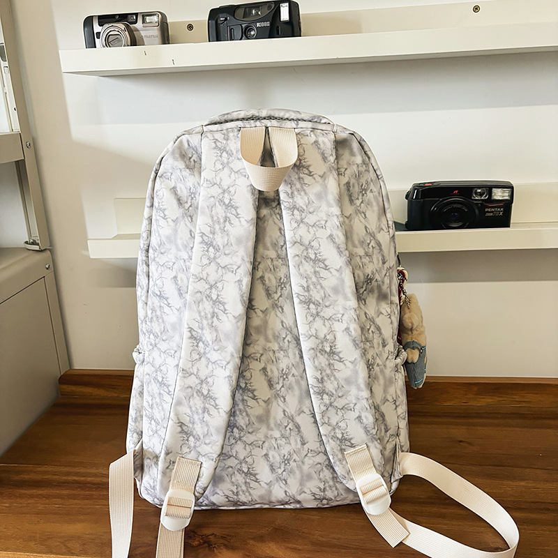 New large-capacity, trendy and versatile schoolbag for junior and senior high school students, couple fashion embossed simple, casual and lightweight backpack Application Scenario