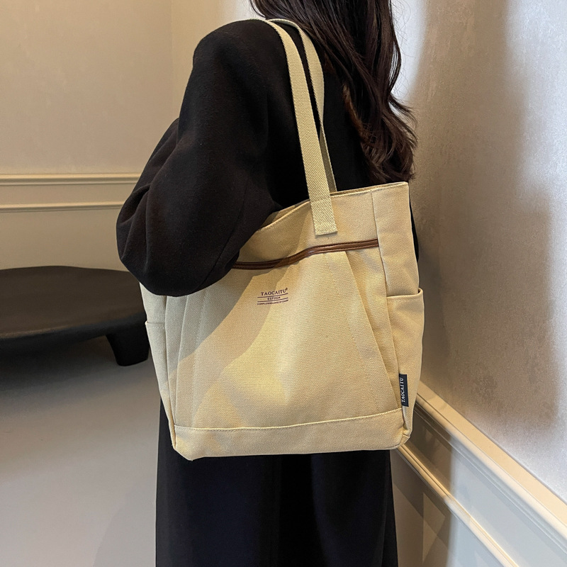 A new Korean-style canvas large bag for women, simple and casual hand-held shoulder bag, versatile texture, student tote bag for class details Picture