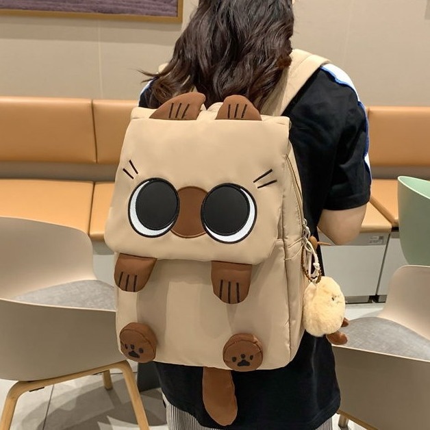 The new Korean version schoolbag is lightweight and has a large capacity. It is a backpack for students in grades three to six and an ugly and cute cat backpack full figure