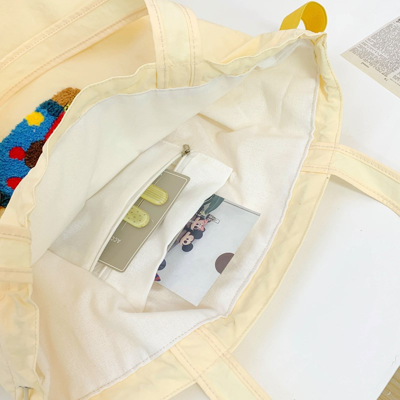 Embroidered cute, versatile, artistic single-shoulder bag, new tote bag, laid-back large-capacity fabric bag, commuting drawstring handbag Application Scenario
