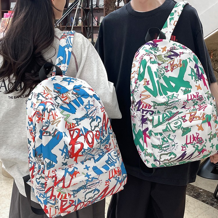 A new Korean-style Instagram backpack with a high level of appearance, trendy and cool personality, and graffiti. It is a lightweight and large-capacity backpack for junior and senior high school students full figure