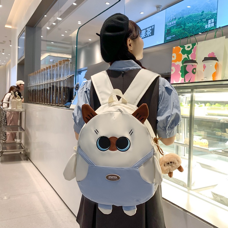 The new Korean version schoolbag is lightweight and has a large capacity. It is a backpack for students in grades three to six and a cartoon cat backpack details Picture