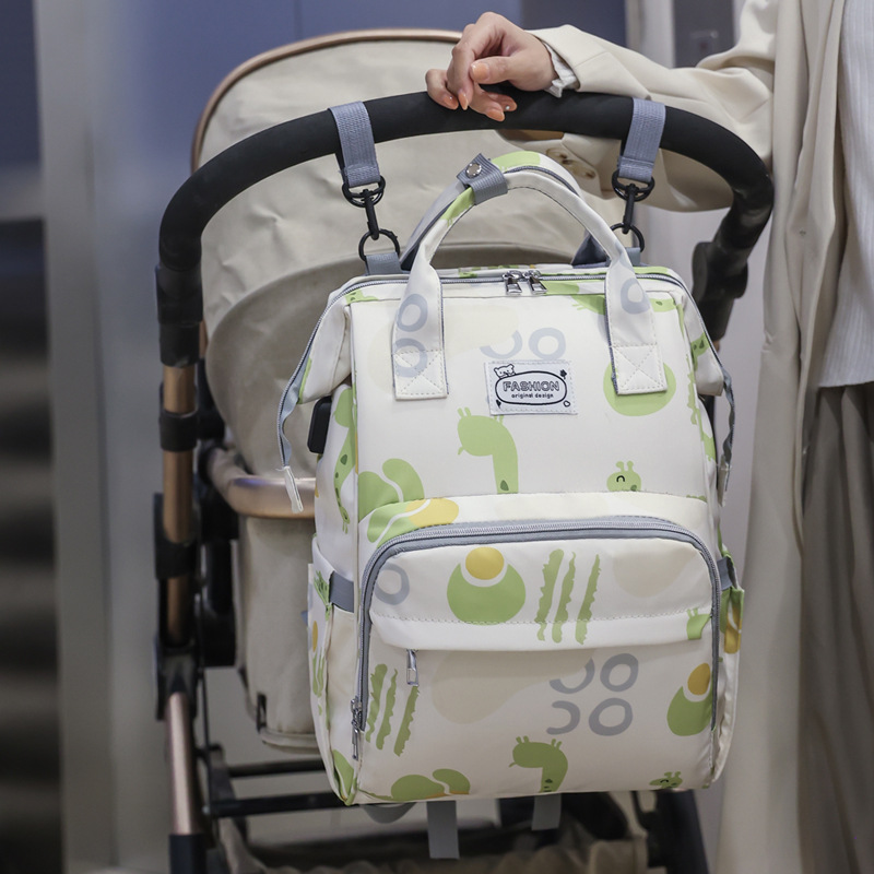 The new mommy bag for foreign trade, a fresh hand-held backpack, has a large capacity and is lightweight for going out. It can be used to hang baby strollers details Picture