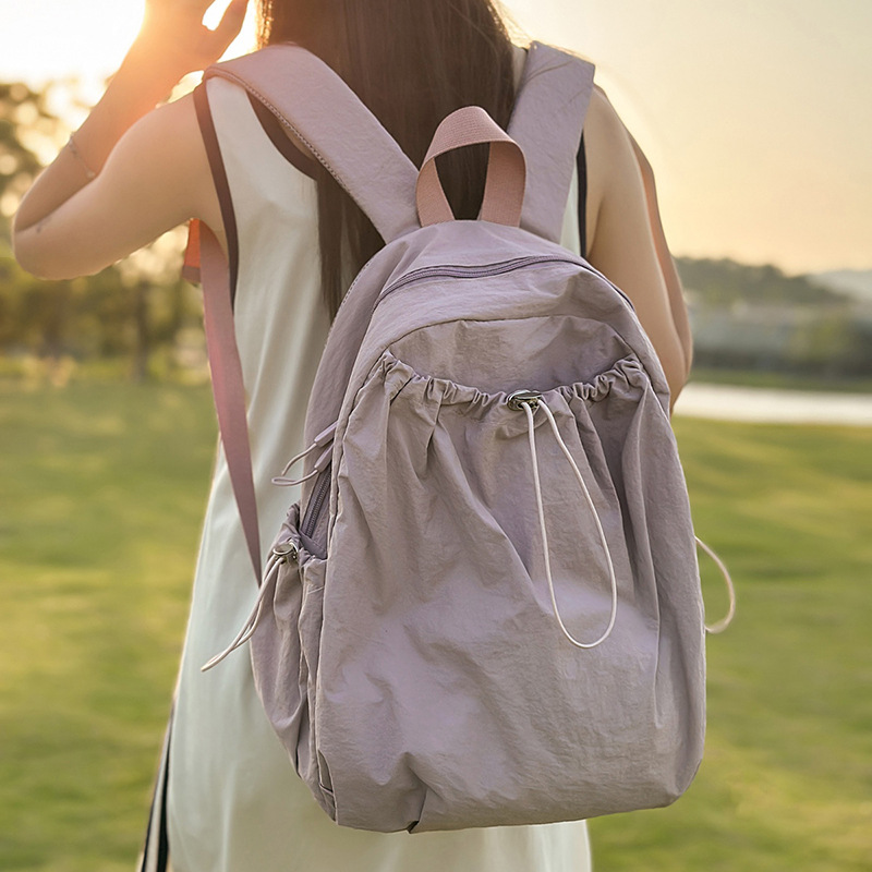 The new Korean-style ins solid-color drawstring backpack is a casual, simple, lightweight and large-capacity travel backpack for junior and senior high school students full figure