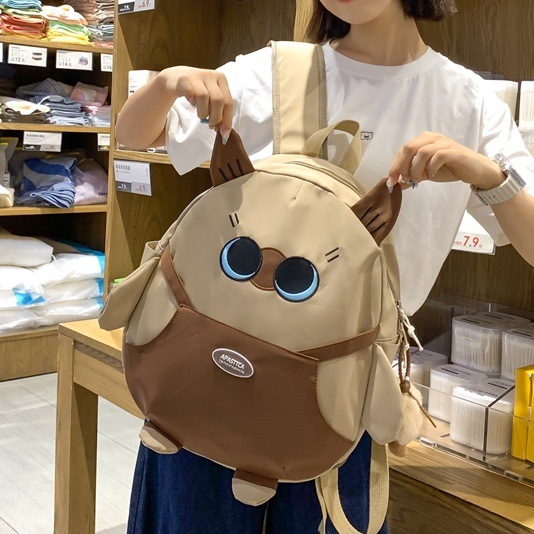 The new Korean version schoolbag is lightweight and has a large capacity. It is a backpack for students in grades three to six and a cartoon cat backpack full figure