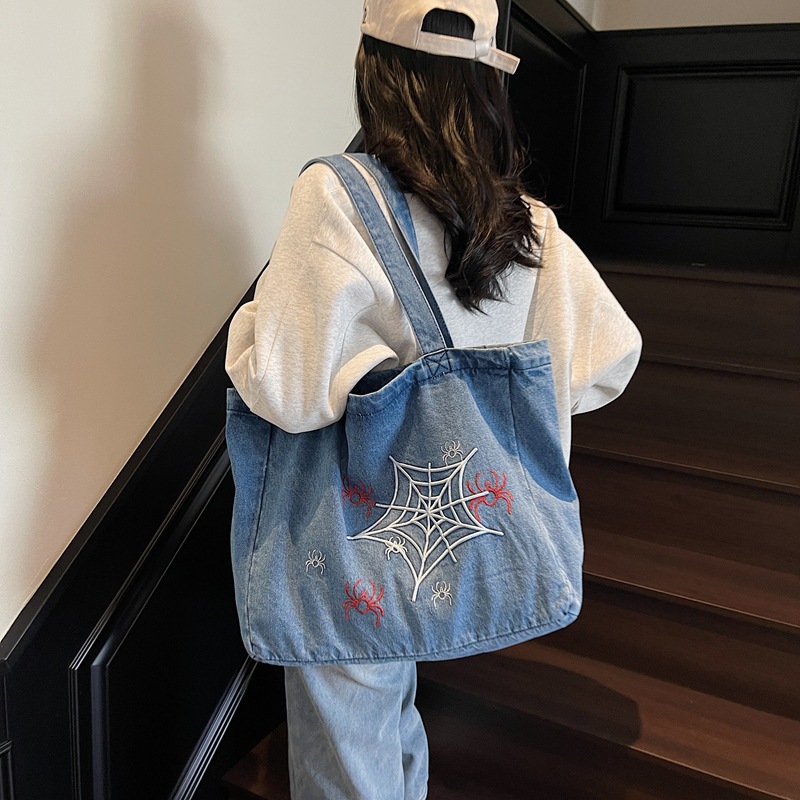 A niche and stylish embroidered denim backpack, a large-capacity versatile tote bag for commuting, and a retro casual student handbag full figure