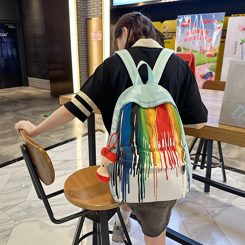 A new high-appearure-level Japanese ins rainbow graffiti backpack for junior and senior high school students, a casual, lightweight and large-capacity backpack full figure