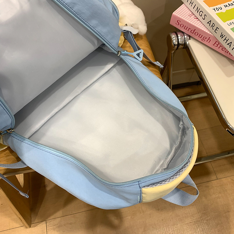 High-appearance-level color-blocking schoolbag for female junior high school students and primary school students in grades three to six, large-capacity multi-layer lightweight and load-reducing backpack Application Scenario