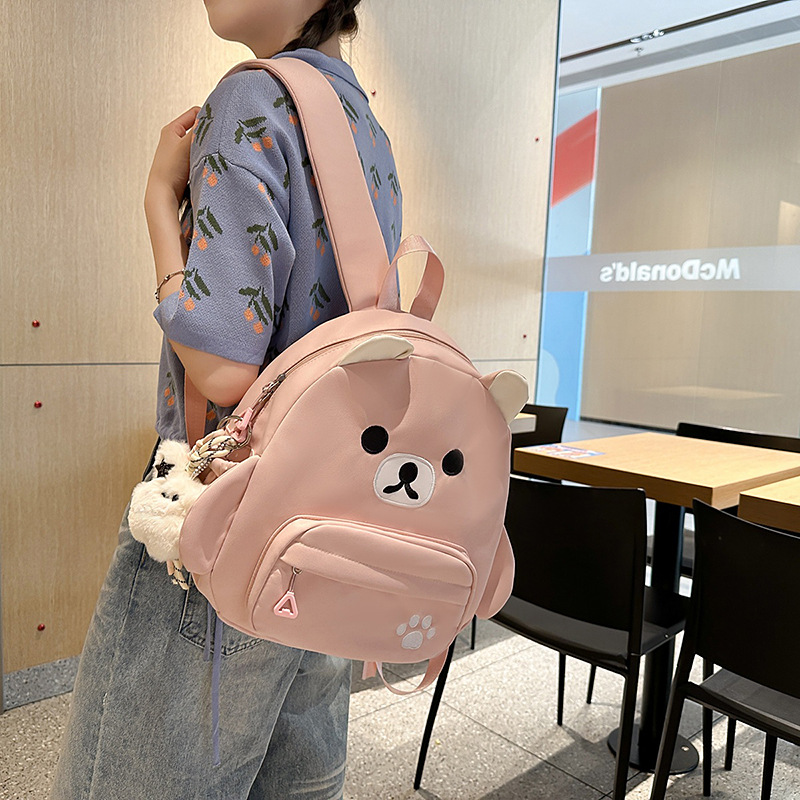 The new Japanese-style cute cartoon canvas bear backpack is a simple, lightweight and versatile large-capacity backpack for primary and secondary school students details Picture