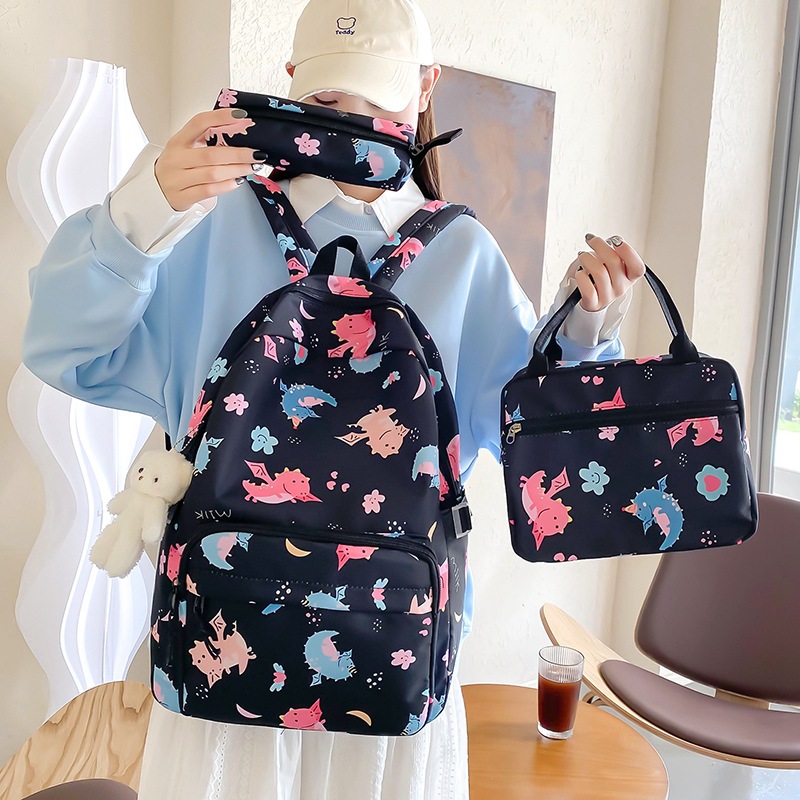 A cute cartoon printed backpack with high appearance level, a fresh and clean schoolbag, and a three-piece set of insulated bento backpacks for girls in junior and senior high school Application Scenario