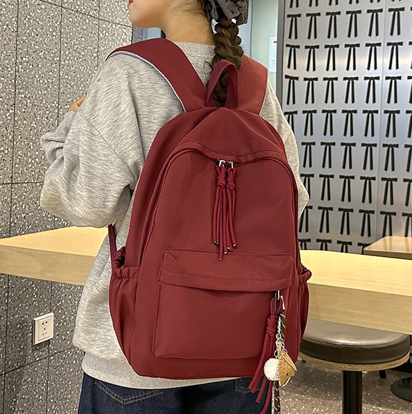 2024 New schoolbag for girls, Korean version, large capacity backpack for junior high school girls and senior high school students, simple and solid color backpack in forest style full figure