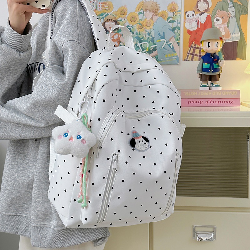 This is an ins style backpack that is versatile and has a high level of appearance. It is a polka dot Korean-style girl's backpack that is lightweight and suitable for junior high school and college students' travel full figure
