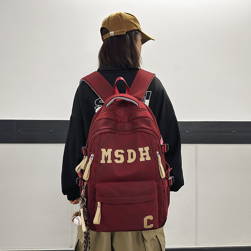 A large-capacity, trendy and casual college student couple backpack with a Korean college style and lettered travel backpack details Picture