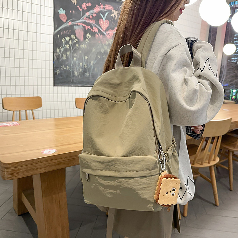 A new minimalist Japanese-style ins solid color backpack for college students, a casual campus schoolbag, and a versatile lightweight backpack for travel details Picture