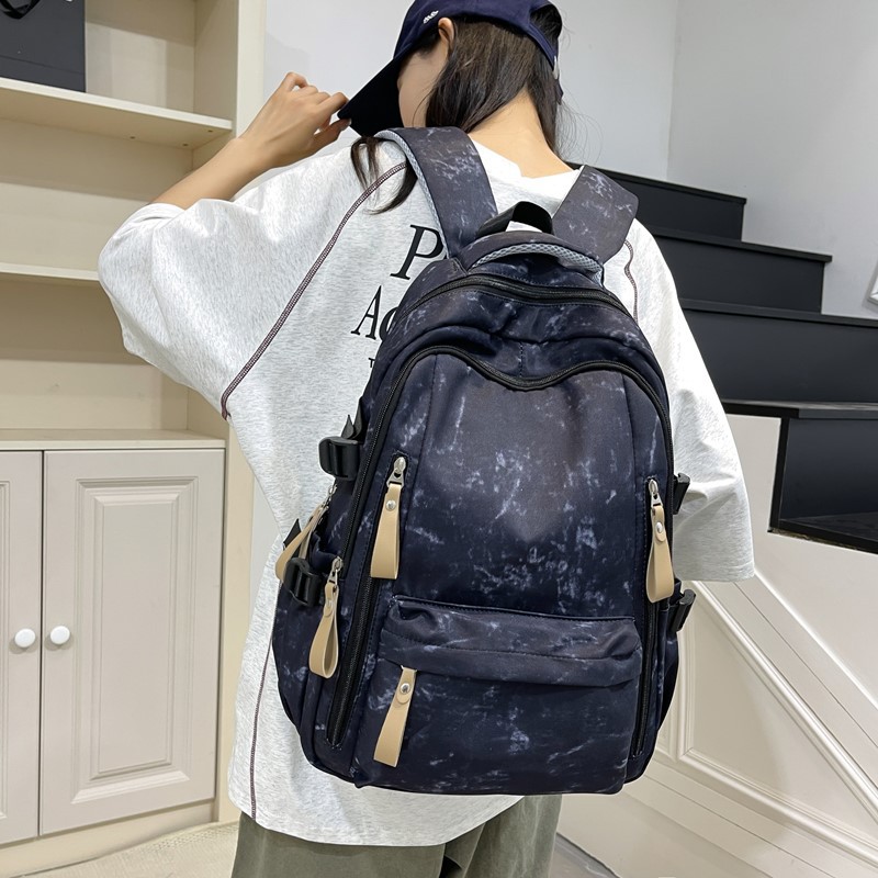 A new high-appearance-level, fresh and sweet tie-dyed backpack for junior and senior high school students, which is light, simple and has a large capacity full figure